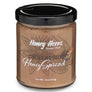 A jar of Honey Acres Chai Spice Honey Spread with a black lid and brown honey spread visible inside, on a white background.